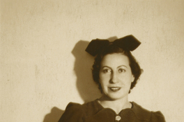 [Mujer de traje oscuro abotonado y una cinta en el pelo]