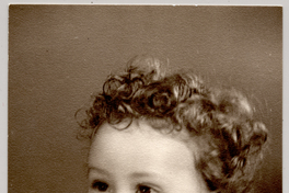 [Niñita de pelo crespo rubio rizado, cara regordeta, sonriente, con un traje de lana abotonado]