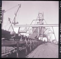 [Carbón conducido por la cinta transportadora hasta el cargador móvil, instalado en el extremo del muelle de embarque]