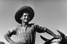 Joven Campesino posa junto a un toro