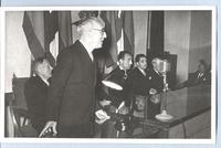 [Acto de inauguración, habla el director de la Biblioteca Nacional de Madrid Don Luis Morales Oliver.Presidente Azorin, el ministro de Educación Joaquín Ruiz Jímenez y el director de Bibliotecas y Archivos Francisco Sintes]