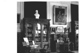 [Biblioteca Nacional. Sala José Toribio Medina, sala del Conservador, se divisan estanterías, un escritorio y cuadros]