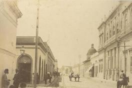 [Calle con transeúntes y carretas]