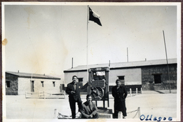 Tres señores, junto a un armazón de madera.