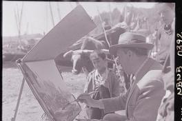 [Niño observa a Arturo Pacheco Altamirano, mientras pinta paisajes en la caleta de Angelmó]